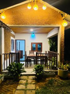a patio with a table and chairs in a house at Topical Mangrove Villa in Tangalle