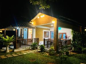 a house with a porch at night with lights at Topical Mangrove Villa in Tangalle +8 photos