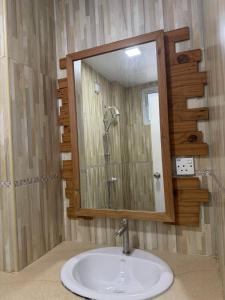 a bathroom with a sink and a mirror at Park View Stay in Male City +34 photos