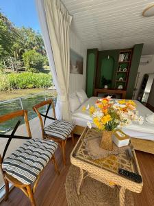 a bedroom with a bed and a table and chairs at Erawan Mountain Beach & Maya Erawan & Goodview Erawan in Tha Kradan