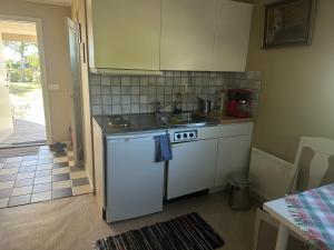 a small kitchen with a sink and a stove at Studio Kustvägen in Mellbystrand