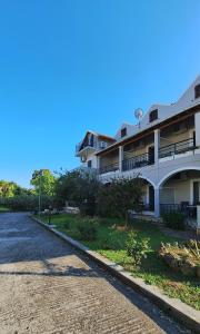 a building on the side of a road at Antzela Apartments in Sidari
