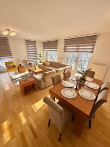 a living room with a table and a couch at Ilidza River Apartments in Sarajevo