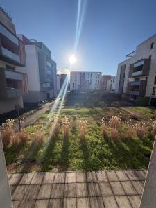 a view of a field in a city with buildings at L'escale du minotaure in Toulouse