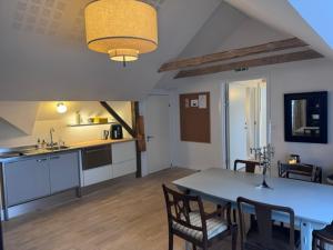 a kitchen and dining room with a table and chairs at Lysbjerggård Bed & Break Herning in Herning +35 photos