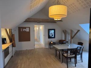 a kitchen and dining room with a table and chairs at Lysbjerggård Bed & Break Herning in Herning