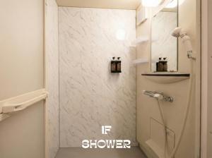 a shower in a bathroom with a white marble wall at MEME Villa 5BR - 3 Separate Toilets & 3 Showers - 10Gbps Wifi in Tokyo +23 photos
