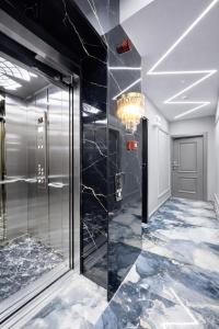 a lobby with a glass elevator and a chandelier at Kilic Boutique Hotel in Istanbul