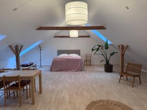 a bedroom with a bed and a table and chairs at Lysbjerggård Bed & Break Herning in Herning