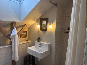 a white bathroom with a sink and a mirror at Lysbjerggård Bed & Break Herning in Herning