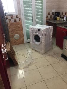 a washing machine sitting on the floor in a kitchen at Beautiful House in Tunis