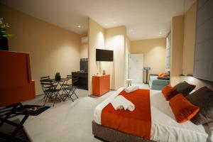 a bedroom with a large bed and a living room at Casa Angelina in Marsala