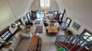 an overhead view of a living room with tables and chairs at Arch Cabins Self Catering Homes Storms River in Stormsrivier