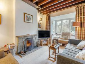 a living room with a couch and a fireplace at 3 Bed in Harrogate oc-87478 in Bouthwaite