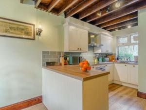 a kitchen with a bowl of oranges on a counter at 3 Bed in Harrogate oc-87478 in Bouthwaite