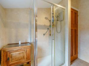 a bathroom with a shower with a wooden cabinet at 3 Bed in Harrogate oc-87478 in Bouthwaite +17 photos