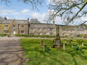 an old house with a fence in front of it at 3 Bed in Harrogate oc-87478 in Bouthwaite