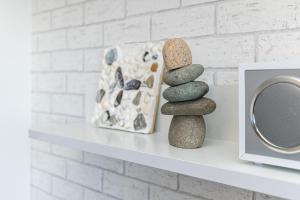a shelf with a stack of rocks next to a mirror at Strandhaferweg 1 Utkiekerblick in Burgtiefe auf Fehmarn  +19 photos