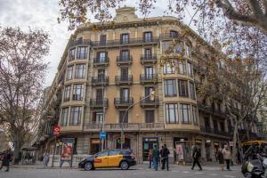 a large building with a car parked in front of it at Storni Barcelona by Forget me not in Barcelona