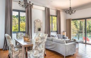 a living room with a couch and a table and chairs at Villa Giorgio by Villa Select in Kefallonia