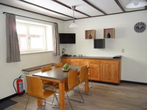 a dining room with a table and chairs at Schophemmerhoeve in Voeren +51 photos