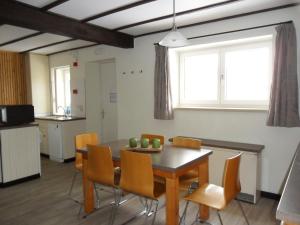 a dining room with a table and chairs at Schophemmerhoeve in Voeren