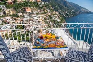 a tray of food on a table on a balcony at Hotel Reginella in Positano