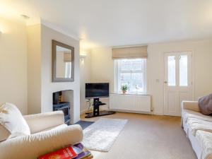 a living room with a couch and a television at 2 Bed in Holt oc-ncc11 in Holt