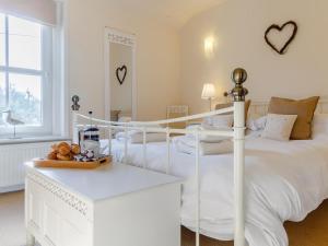 a white bedroom with a white bed and a window at 2 Bed in Holt oc-ncc11 in Holt