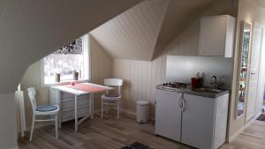 a kitchen with a counter and a table in a room at Ormåsen Loft in Ormåsen