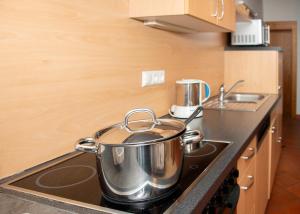 a large pot sitting on top of a stove in a kitchen at Seehütte Tamberger in Feld am See