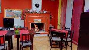 a dining room with a table and a fireplace at Bed & Breakfast Valeri in Artena