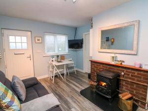 a living room with a couch and a fireplace at Long Jack's in Ballygarrett