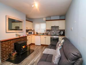 a living room with a couch and a fireplace in a kitchen at Long Jack's in Ballygarrett