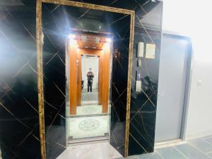 a man taking a picture in a mirror at Urban Nest - Đông Ngạc in Hanoi +5 photos