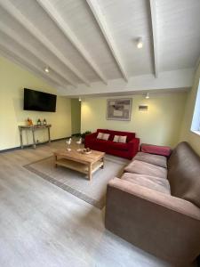 a living room with a couch and a table at Casa Ferrari pichilemu in Pichilemu