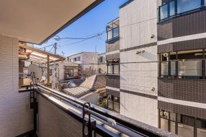 a balcony with a view of a building at 春日居 Kasuga House in Tokyo