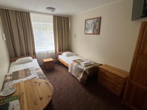 a hotel room with two beds and a window at Dorell in Tallinn