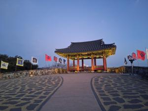 a gazebo on the side of a road at Dongpirang Purple House 2 in Tongyeong