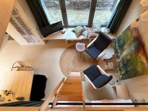 an overhead view of a living room with stairs and chairs at de KruidenPoort in Woudrichem