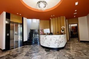 a lobby with a reception desk and a staircase at Vila Lira in Durrës