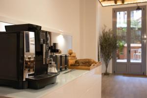 a room with a coffee machine on a counter at Storni Barcelona by Forget me not in Barcelona