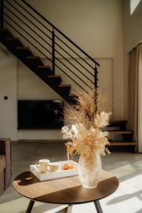 a vase with a tray of food on a table in a room at Malou and Charma Villas in Syvota