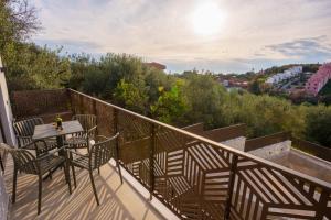 a balcony with a table and chairs and a view at Malou and Charma Villas in Syvota
