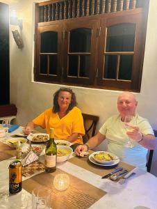 a man and woman sitting at a table eating food at Bay Street in Beruwala +31 photos