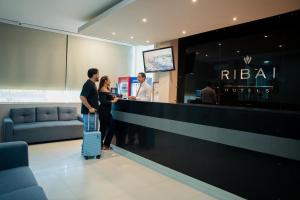 a group of people standing at a hotel reception counter at Ribai Hotels -Riohacha in Ríohacha