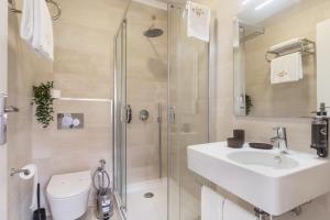 a bathroom with a shower and a sink and a toilet at Duques Villa Luxury Guesthouse in Lisbon +72 photos