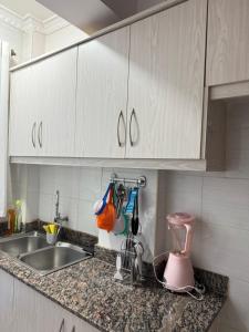 a kitchen counter with a sink and a mixer at Beytumn Luxury Apartment - Ruiru in Nairobi +6 photos