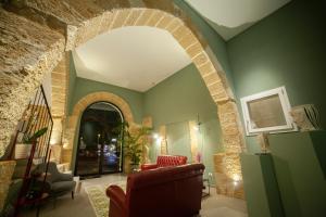 an archway in a living room with a couch and chairs at Casa Angelina in Marsala