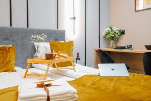a bedroom with a bed with a laptop on it at S12 Premium Apartments - by Hosty in Krakow